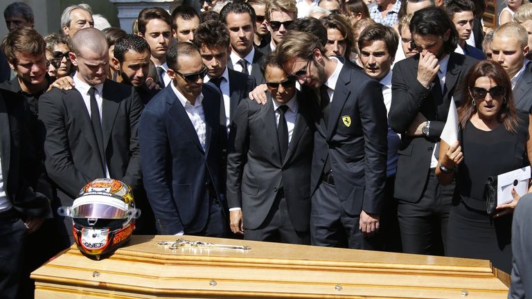 Jean-Eric Vergne (C-R) and fellow driver Brazilian Felipe Massa (C-L) stand with other friends and relatives in front of Jules Bianchi's coffin