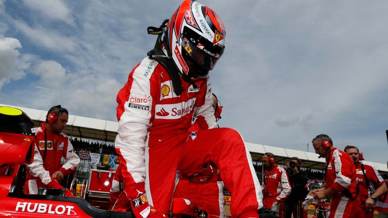 Kimi Raikkonen climbs out of his Ferrari on the grid