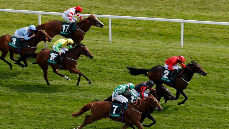 Lathom ridden by Tony Hamilton (right) wins the Weatherbys Super Sprint at Newbury Racecourse.