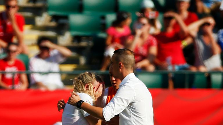 Laura Bassett #6 is consoled by Mark Sampson of England after Bassett's pass resulted in a goal and a win for Japan during the Women's World Cup semi-final