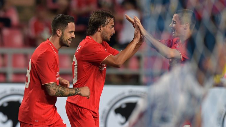 Liverpool football player Lazar Markovic (C) celebrates with his team after scoring against the Thailand All Stars