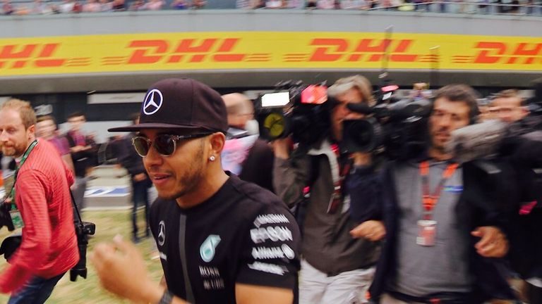 Race winner Hamilton makes a dash for the throng of fans - and the photographers and cameramen give chase!