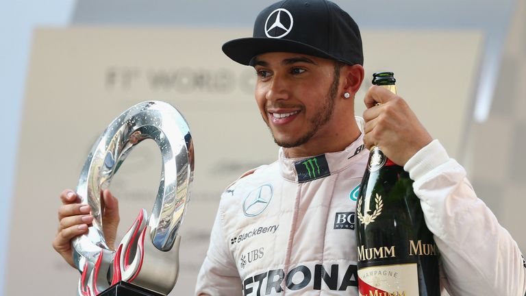 Lewis with his race winner's spoils from China