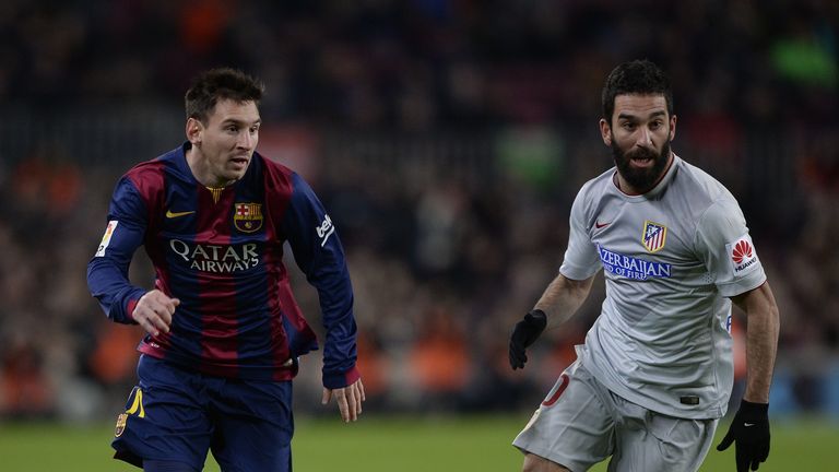Lionel Messi vies with Arda Turan during the Spanish Copa del Rey quarter final between Barcelona and Atletico Madrid at the Camp Nou