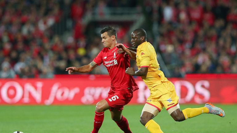 Dejan Lovren of Liverpool and Bruce Djite compete for the ball