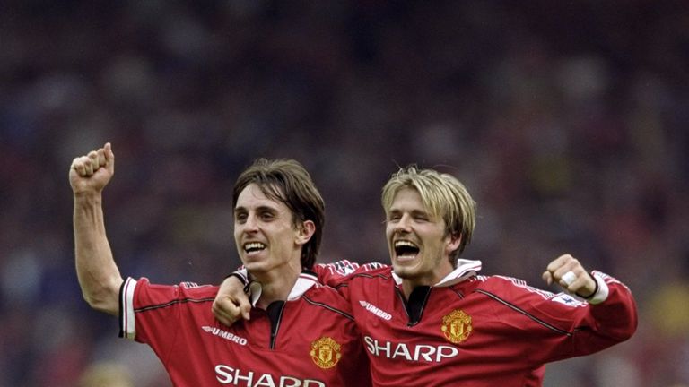 Neville celebrates winning his third Premier League crown with old pal David Beckham