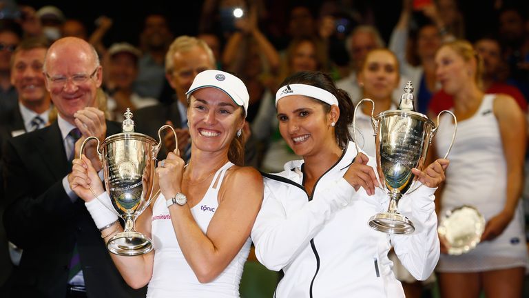 Sania Mirza and Martina Hingis celebrate with their trophies