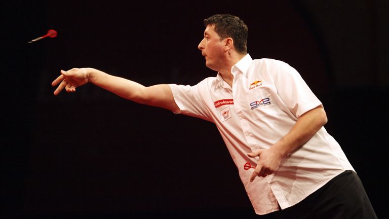 Austria's Mensur Suljovic throws a dart during his match against England's Kevin Painter  at the World Darts Championship in London's Alexandra Palace on D