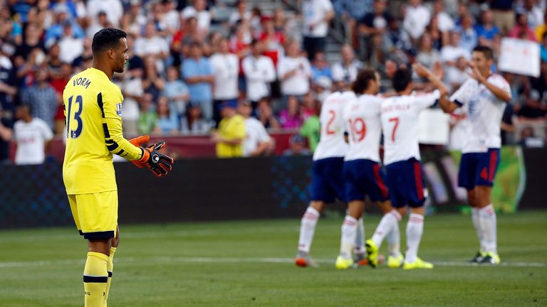 Tottenham goalkeeper Michel Vorm looks on as David Villa (7) celebrates with his team-mates 