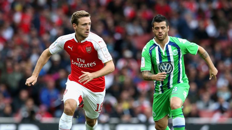 Nacho Monreal of Arsenal is tracked by Vieirinha during the Emirates Cup match between Arsenal and Wolfsburg