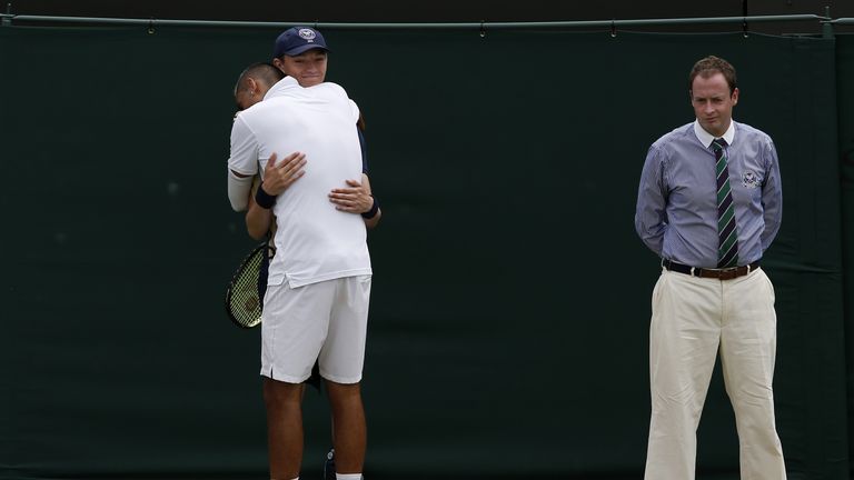 Australia's Nick Kyrgios gives a ball-boy a hug at the start of a game in the third set against France's Richard Gasquet 