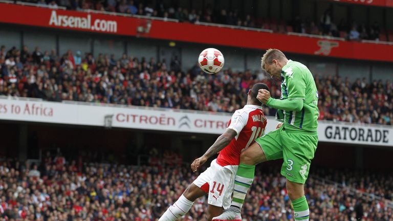 Wolfsburg's Nicklas Bendtner (R) vies with Arsenal's Theo Walcott during the Emirates Cup match at The Emirates Stadium in north London on July 26, 2015.