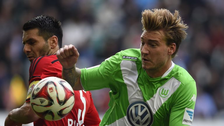 Wolfsburg's Danish forward Nicklas Bendtner (R) and Leverkusen's Bosnian defender Emir Spahic vie for the ball vie for the ball during the German first div