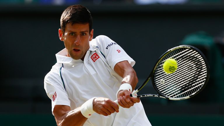 Novak Djokovic of Serbia plays a backhand in his Gentlemens Singles Quarter Final match against Marin Cilic of Croatia during day nine of the Wimbledon 