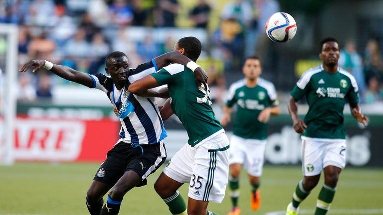 Papiss Cisse battles for the ball against Portland Timbers 