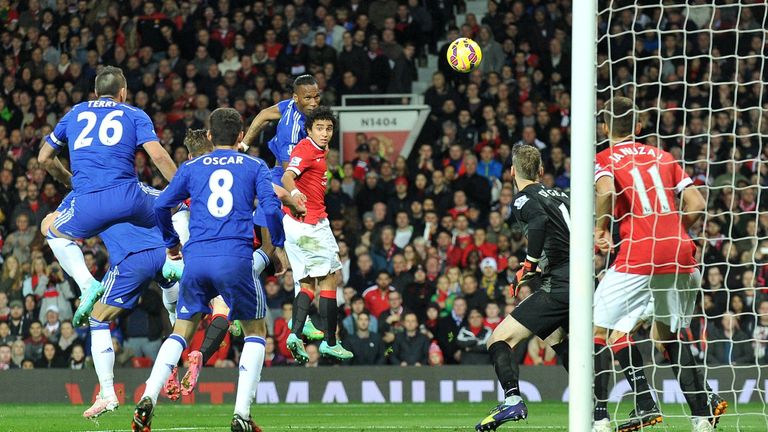 Chelsea's Didier Drogba jumps above Rafael to score against Manchester United.