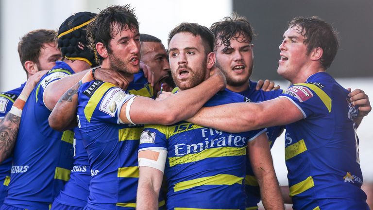 Warrington's Richie Myler is congratulated on his try by team-mates.