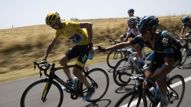 Richie Porte (right) gives a feeding-bottle to Chris Froome during the 13th stage of the Tour de France
