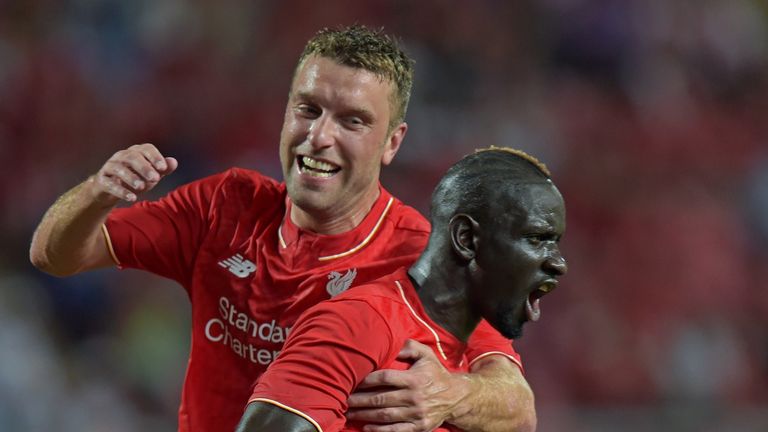 Liverpool football players Mamadou Sakho (R) celebrates with Rickie Lambert (L) after scoring against Thailand All Stars
