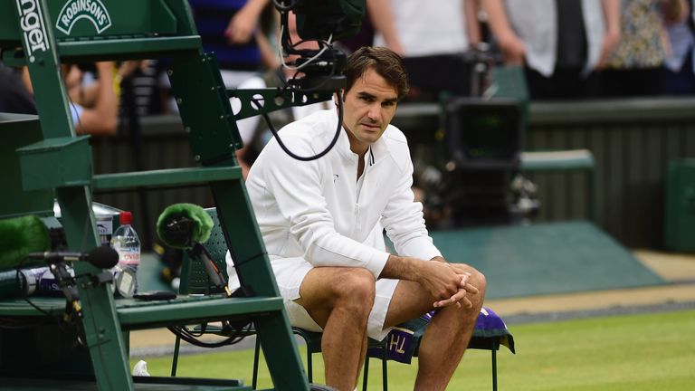 Roger Federer of Switzerland looks dejected after losing in the Final Of The Gentlemen's Singles to Novak Djokovic of Serbia on
