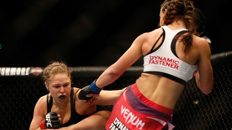 LAS VEGAS, NV - DECEMBER 28:  (R-L) Miesha Tate kicks Ronda Rousey in their UFC women's bantamweight championship bout during the UFC 168 event at the MGM 