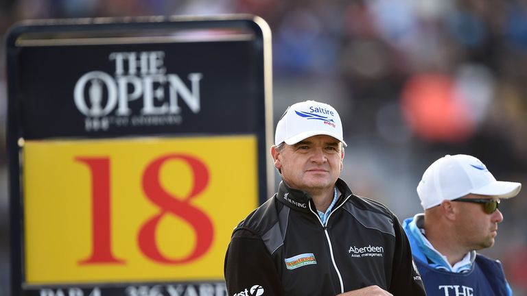 Paul Lawrie of Scotland and caddie Danny Kenny look on from the 18th tee during the second round of the 144th Open Championship