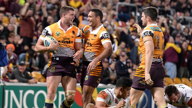 Corey Oates of the Broncos celebrates with team-mate Justin Hoges after scoring their eighth try against Wests Tigers