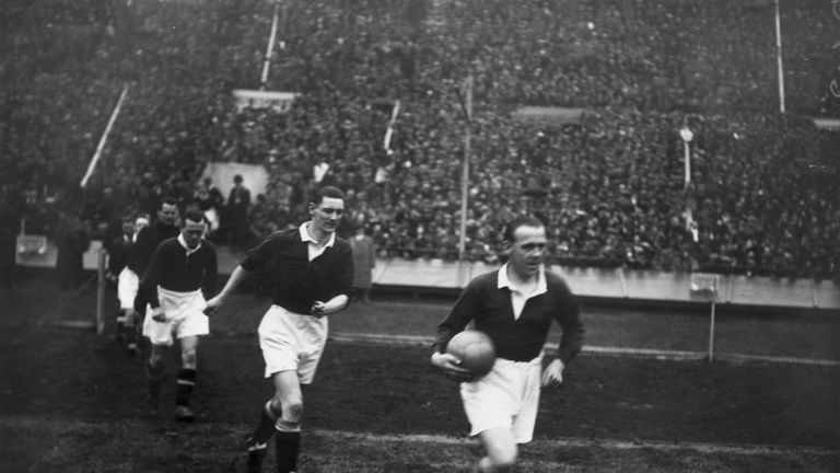 The Scottish captain Jimmy McMullan leads out his team before Scotland's famous Wembley win in 1928