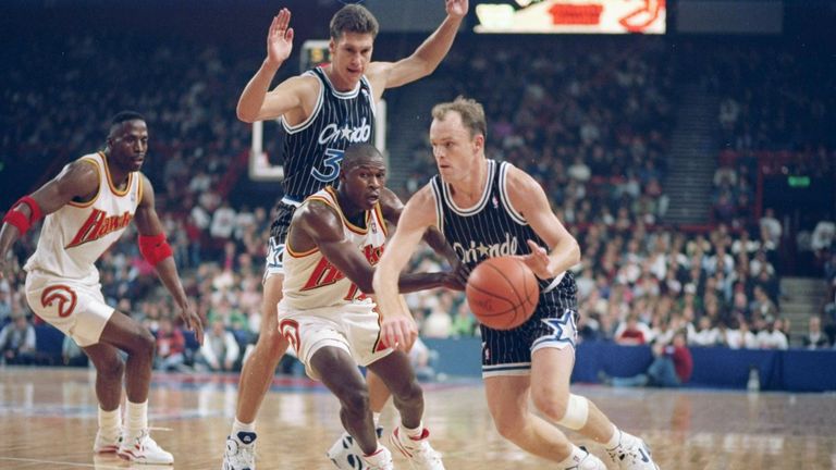 Guard Scott Skiles of the Orlando Magic (right) drives the ball down the court during a game against the Atlanta Hawks at Wembley Stadium in London