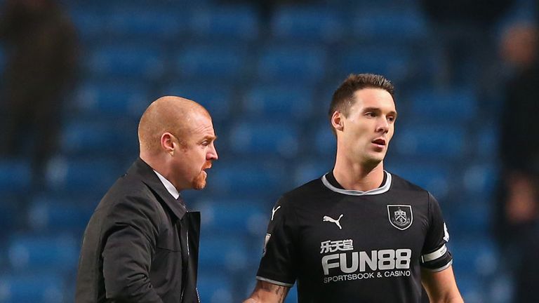 Manager Sean Dyche of Burnley shakes hands with Jason Shackell of Burnley during the Barclays Premier League match at Etihad Stadium on December 28, 2014