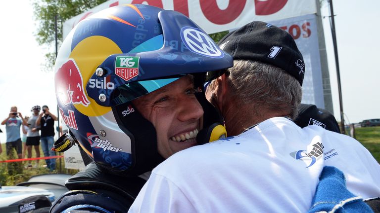 Sebastien Ogier (L) celebrates after winning the seventh round of Lotos Rally Poland 