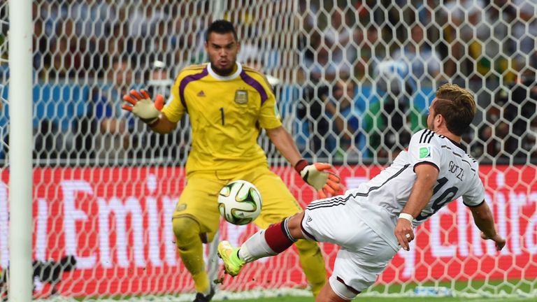 RIO DE JANEIRO, BRAZIL - JULY 13:  Mario Goetze of Germany scores his team's first goal past Sergio Romero of Argentina in extra time during the 2014 FIFA 