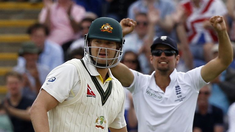 England's Captain Alastair Cook (R) celebrates after Australia's Shane Watson (L) loses his wicket
