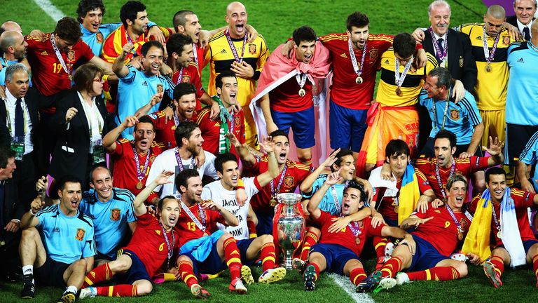 Spain players and coaching staff celebrate with the trophy following victory in the UEFA EURO 2012 final match between Spain and 