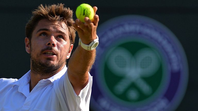 Stan Wawrinka serves to Dominican Republic's Victor Estrella Burgos during their men's singles second round match on day three of the 2015 Wimbledon 
