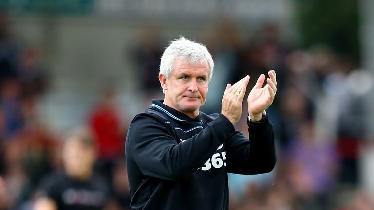 Stoke manager Mark Hughes applauds the fans after the friendly against Brentford