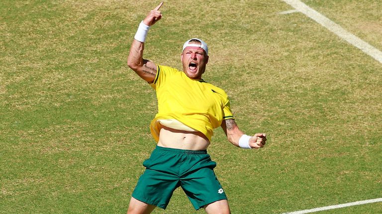 Sam Groth of Australia celebrates match point after winning the reverse singles match against Mikhail Kukushkin in the Davis Cup