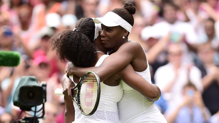 Serena Williams (left) and Venus Williams embrace after their match during day seven of Wimbledon