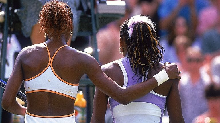 Venus Williams (left) of the USA consoles her sister Serena after womens semi-final at Wimbledon