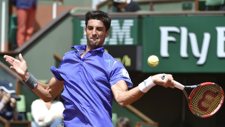 Thomaz Belluci returns the ball to Kei Nishikori during the men's second round of the 2015 French Open