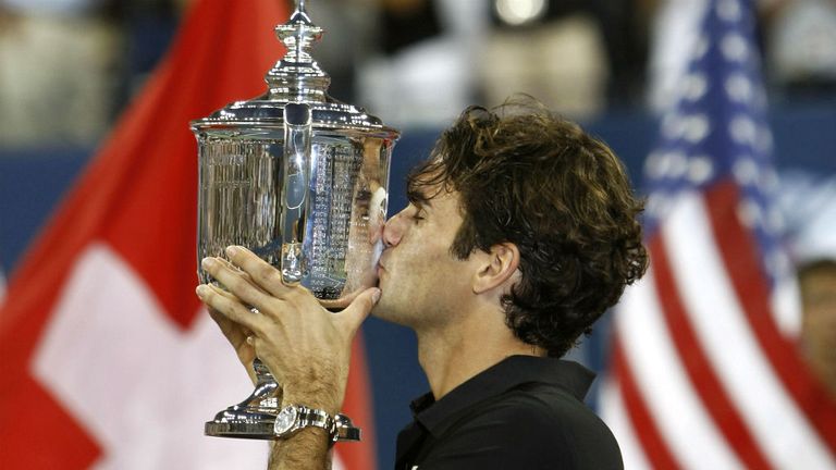 Roger Federer celebrates with the trophy after defeating Novak Djokovic at 2007 US Open men's title