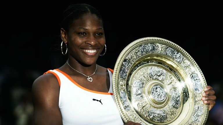 Serena Williams lifts the trophy up after her victory over sister Venus at Wimbledon 2003