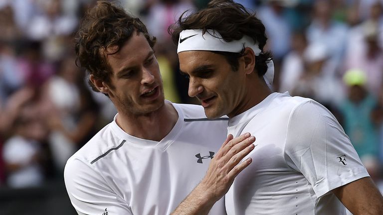 Andy Murray (L) talks with Switzerland's Roger Federer after losing to him in their men's semi-final match at Wimbledon