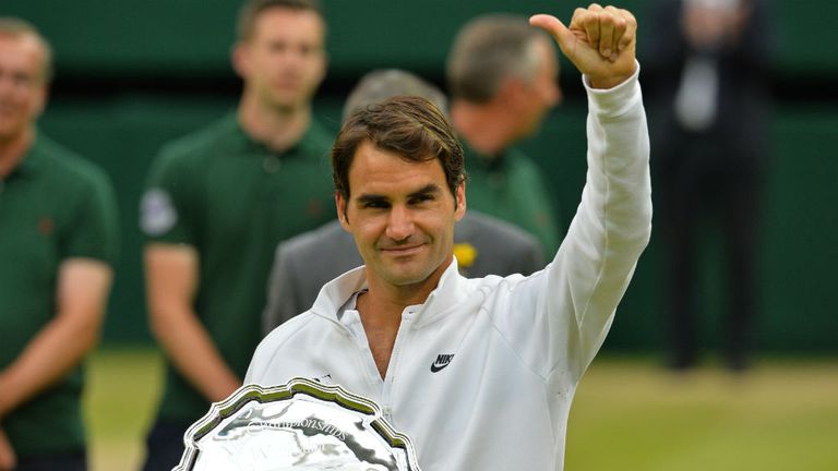 Roger Federer holds his runners-up trophy after losing to Novak Djokovic in the 2015 Wimbledon final