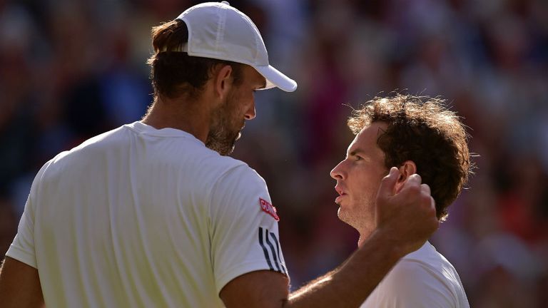 Ivo Karlovic (L) talks with Andy Murray during Wimbledon Championships