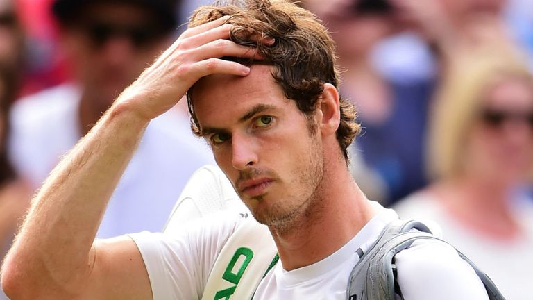 Andy Murray looks dejected after his semi-final defeat against Roger Federer at Wimbledon