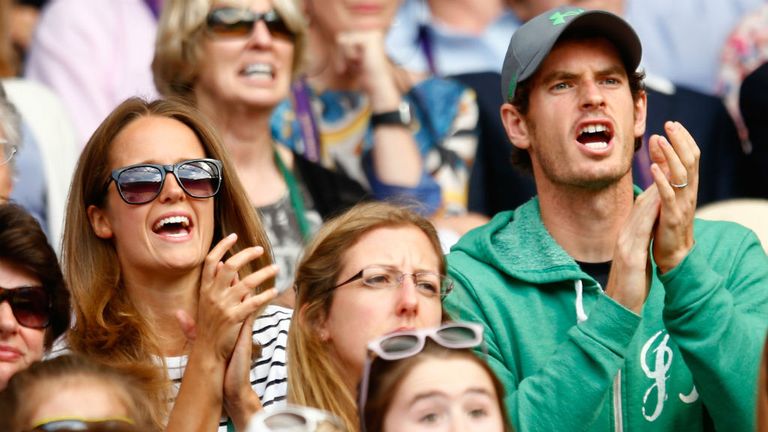 Kim and Andy Murray watch John Peers of Australia and Jamie Murray of Great Britain in action at Wimbledon