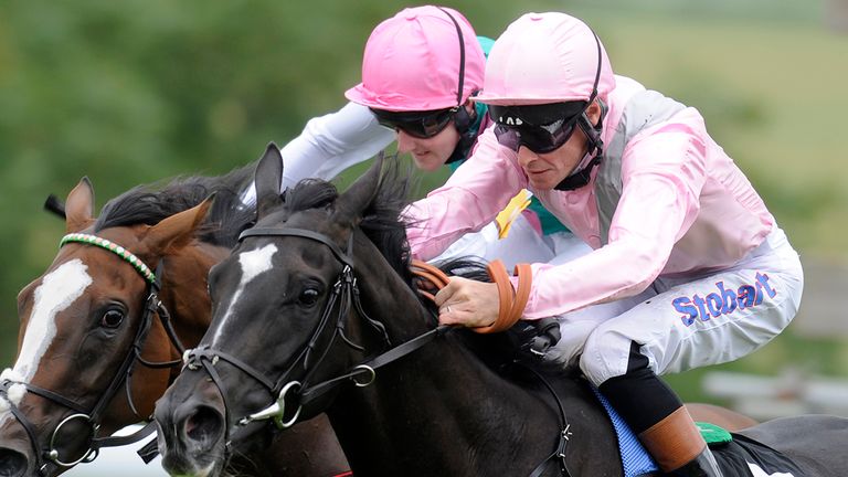 Richard Hughes riding The Fugue (R) win The Markel Insurance Nassau Stakes from Timepiece (L) at Goodwood  in 2012