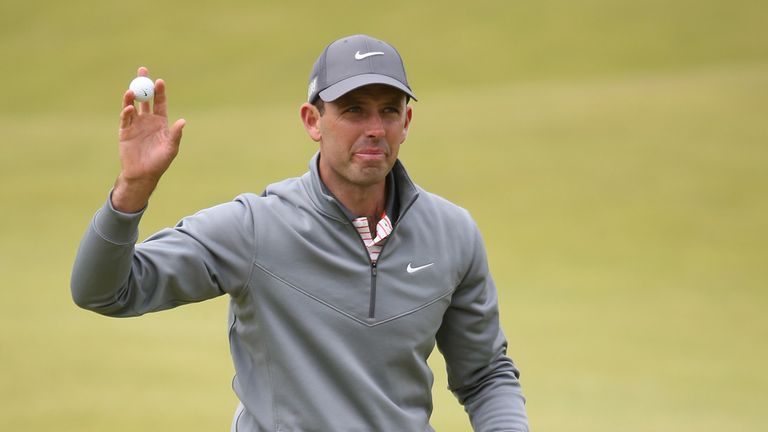 Charl Schwartzel of South Africa acknowledges the crowd on the 18th green