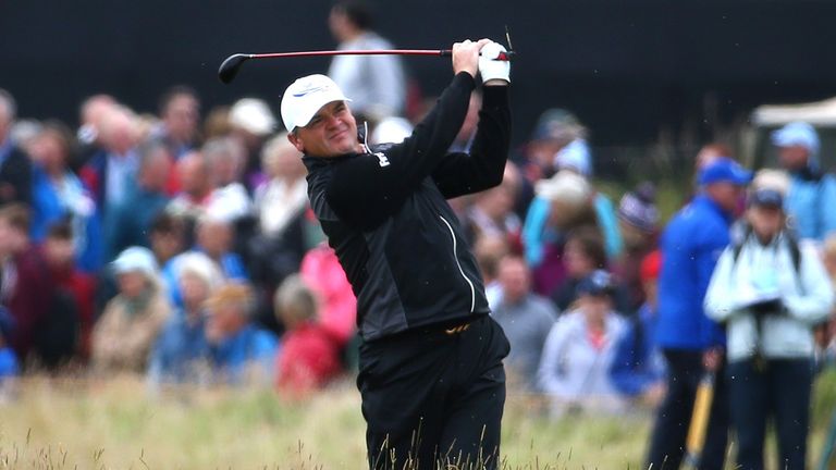 Paul Lawrie of Scotland plays his second shot on the 4th hole during the first round of the 144th Open Championship